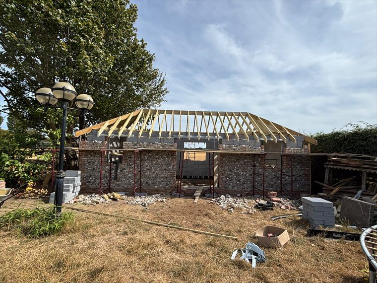 Hipped roof structure going on