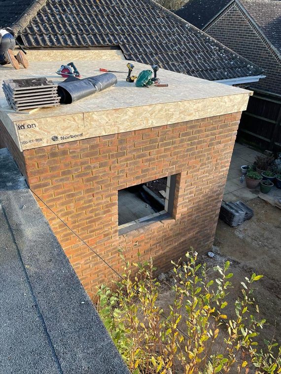 Brick-faced extension with its new roof