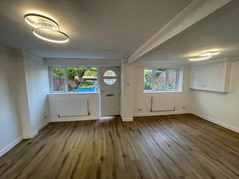 Finished living space with new flooring and lighting