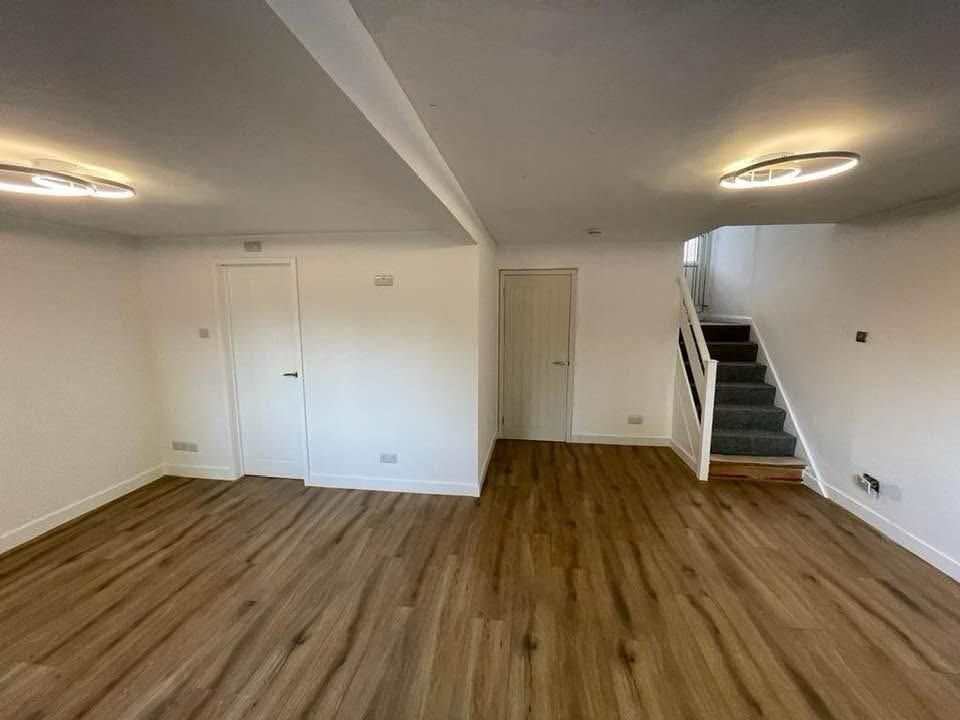 The same view after completion, a finished living space with new flooring