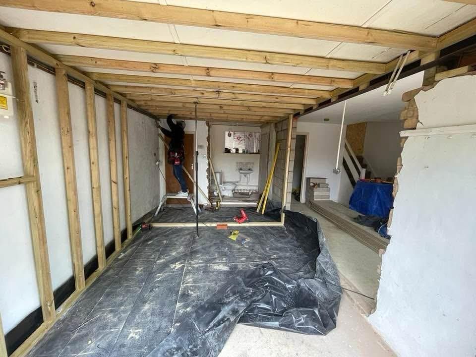 The converted garage during works, with the new stud walls framed out