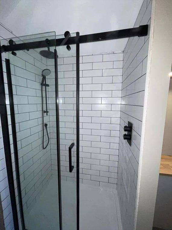 Walk-in shower with black fittings