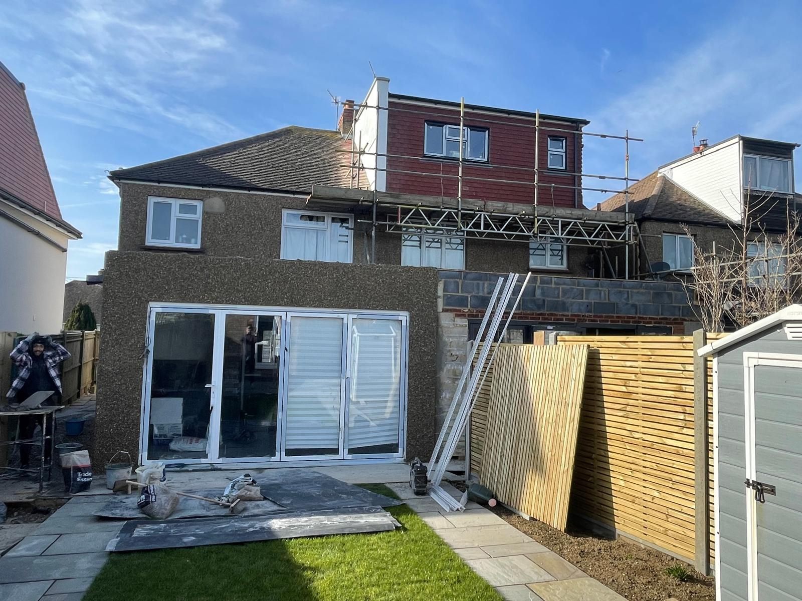 Completed rear elevation of the two neighbouring homes, with bi-fold doors and a new dormer